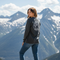 Person wearing a branded long-sleeve shirt with mountains in the background